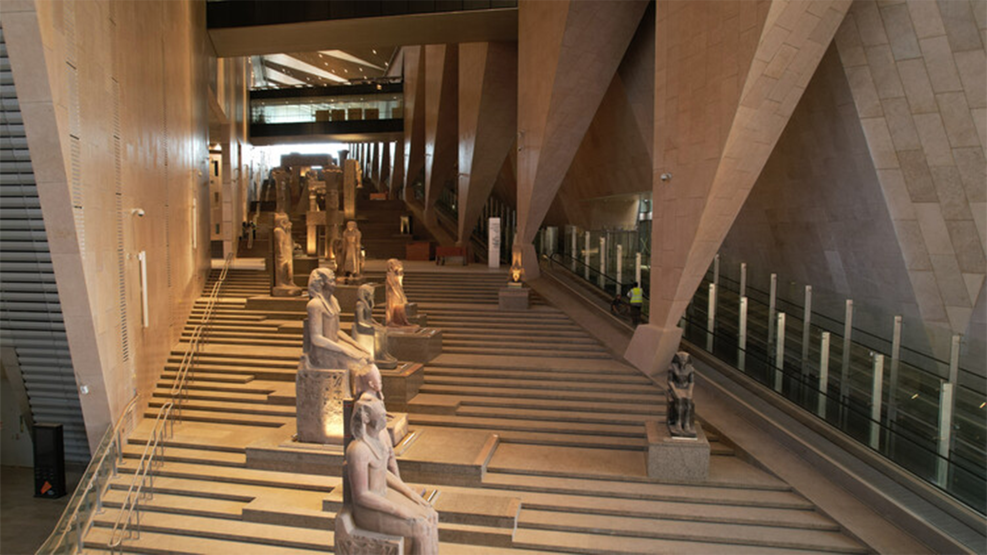 Interior hall of the Grand Egyptian Museum galleries displaying ancient Egyptian artifacts in Cairo